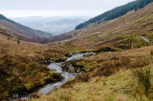 Sombre Scottish landscape. Looking back down the burn  to Loch Ard